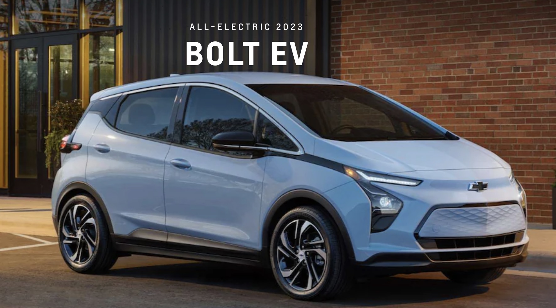 2023 Chevolet Bolt EUV parked in front of a brick building.