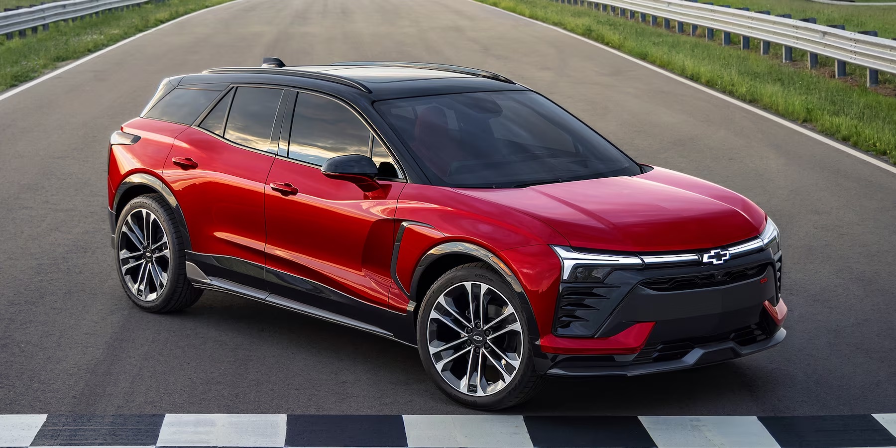 2024 Chevy Blazer EV at the finish line of a race car track. Turned to the side in a red color