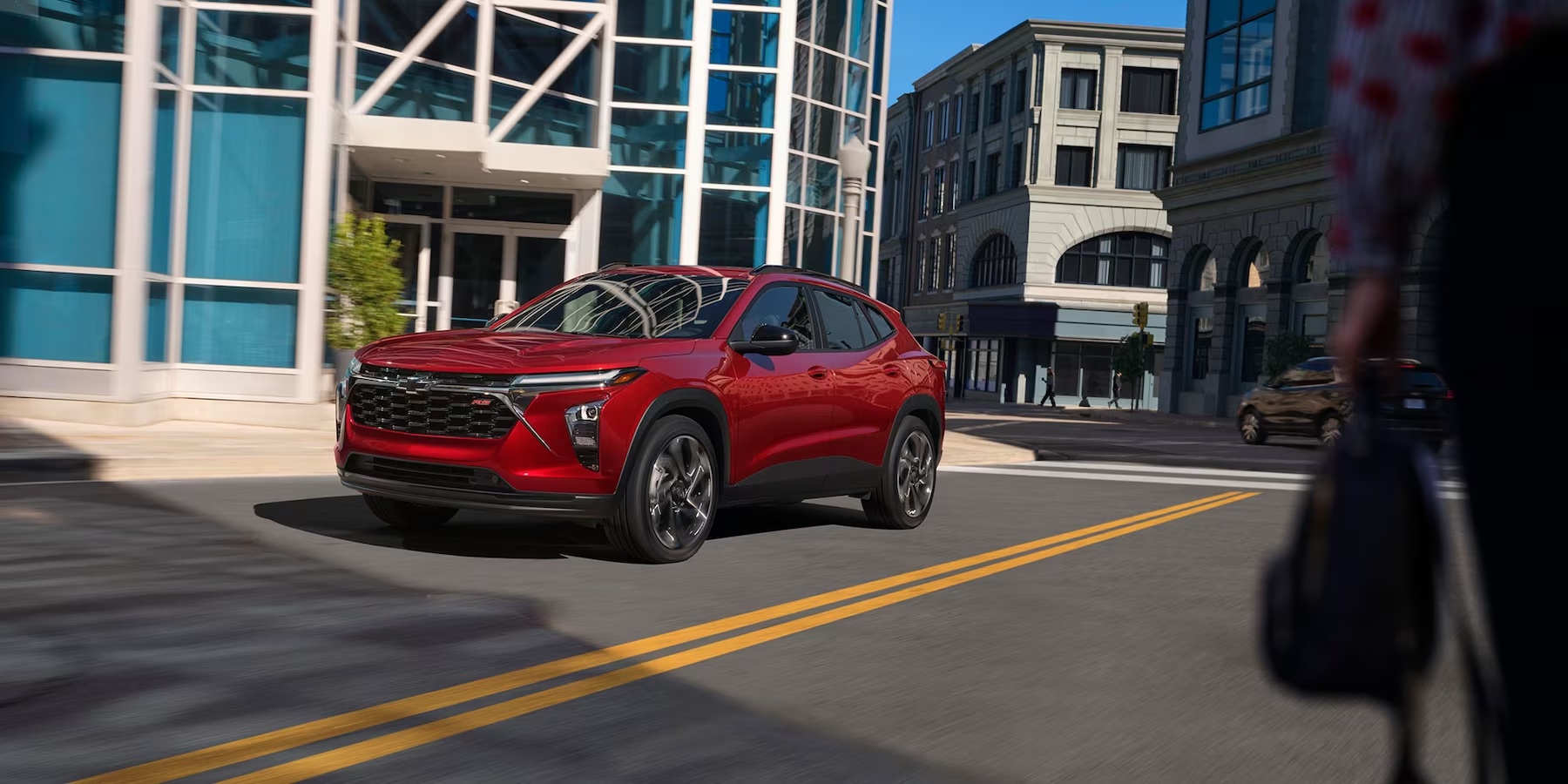 Three Quarters view of the 2RS in Crimson on the road in a city