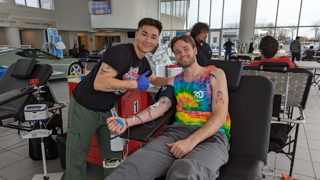 person donating blood at lou bachrodt chevrolet's blood drive