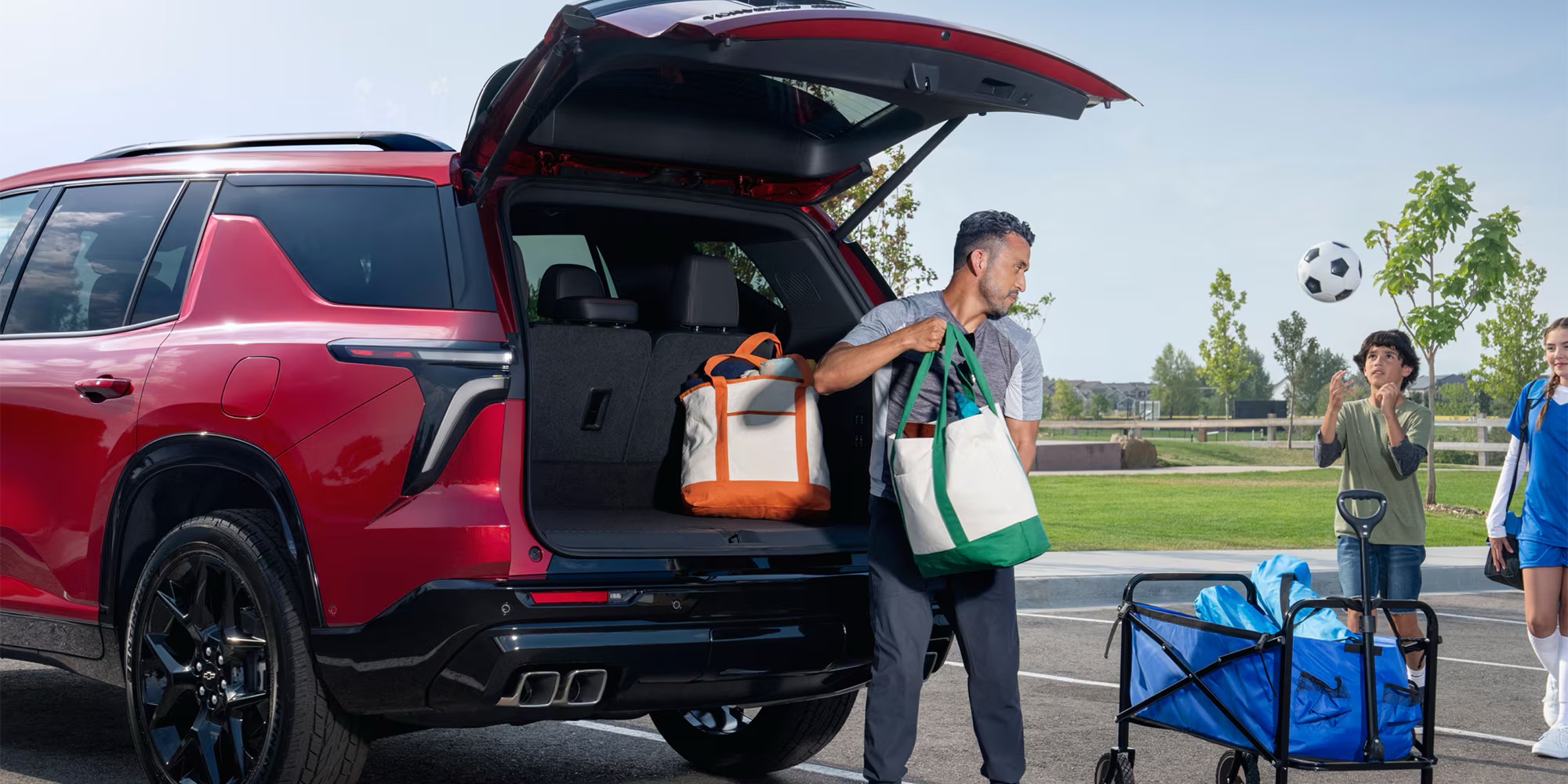family unloading a 2025 Chevy vehicle for soccer practice