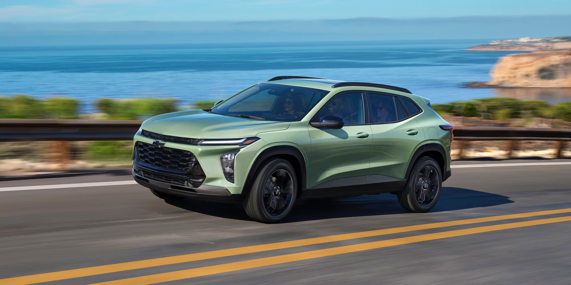 A green 2026 Chevy Trax driving through Rockford, IL