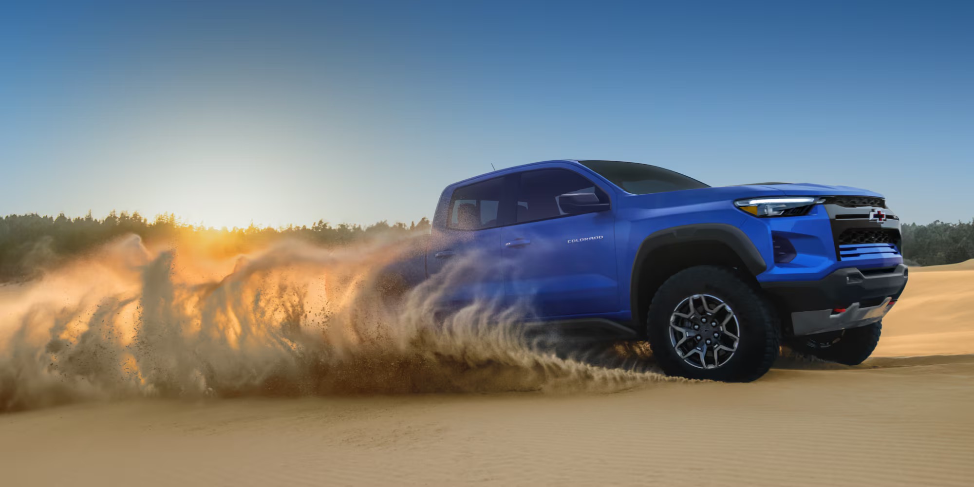 A blue 2026 Chevrolet Colorado driving in desert